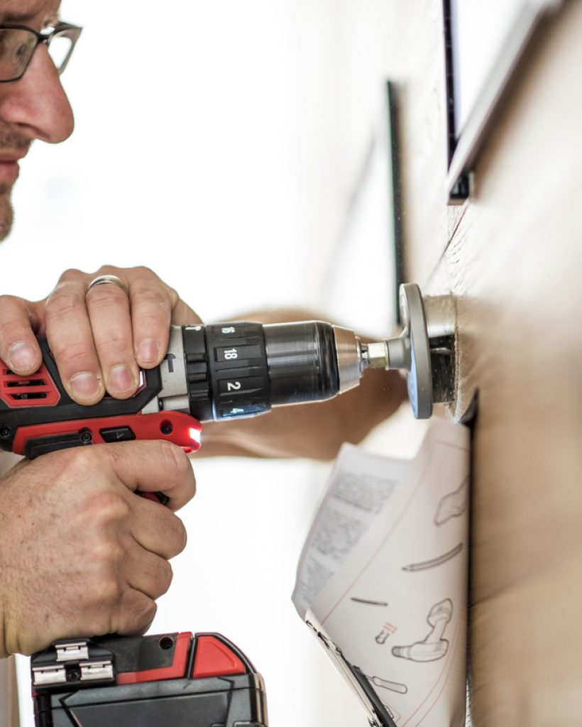 Closeup photo of a handyman using a drilling machine