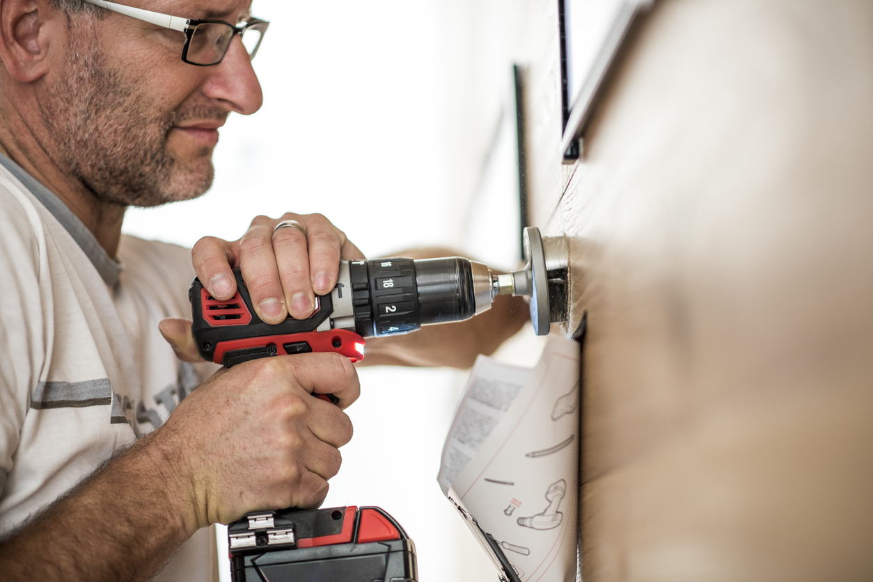 Closeup photo of a handyman using a drilling machine